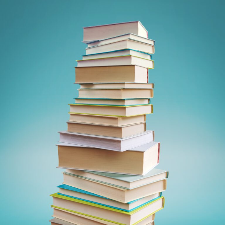 Many stacked books on blue background