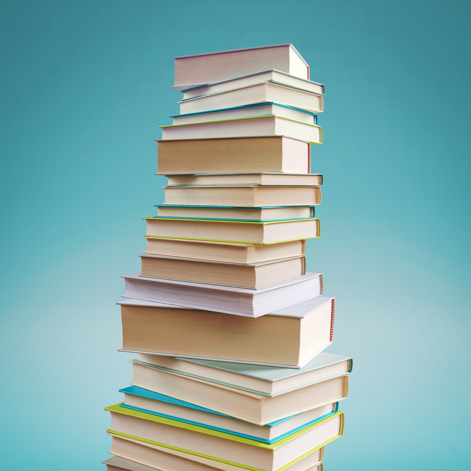 Many stacked books on blue background